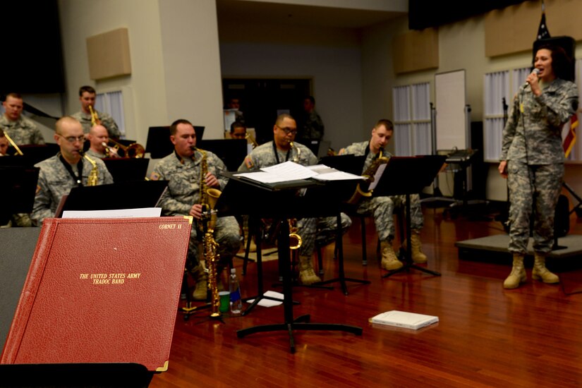 U.S. Army Spc. Anna Leverenz, Army Training and Doctrine Command Band musician, sings “Let it Snow” during the band’s concert rehearsal at Fort Eustis, Va., Dec. 9, 2013. Days before the concert, the group ran through the entire performance to work on transitions between the songs and familiarize themselves with the overall flow of the presentation. (U.S. Air Force photo by Staff Sgt. Ashley Hawkins/Released)