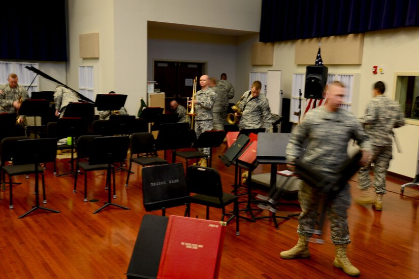 Members of the U.S. Army Training and Doctrine Command Band set up for practice for an upcoming concert at Fort Eustis, Va., Dec. 9, 2013. The band spends hours daily practicing individually and as a group to perfect their skills before performing before a crowd. (U.S. Air Force photo by Staff Sgt. Ashley Hawkins/Released)
