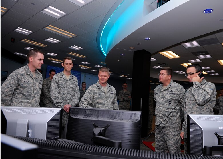Col. Bill Liquori, 50th Space Wing commander, (far right) accepts satellite control authority of the Wideband Global SATCOM-6 satellite from the 14th Air Force and delegates SCA to Lt. Col. Chadwick Igl, 3rd Space Operations Squadron commander, (center) here Dec. 17.    