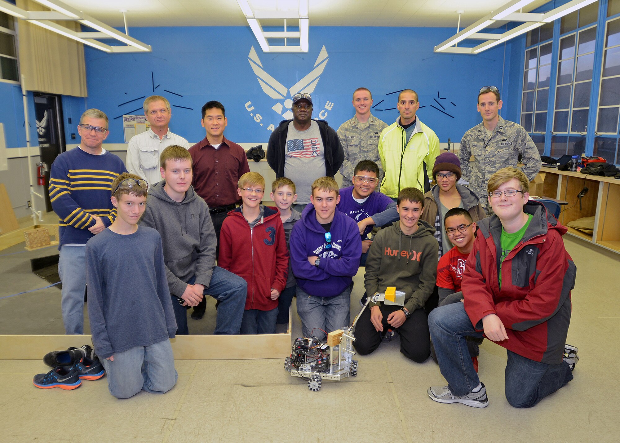 The newly-formed Desert Jr. and Sr. High School Scorpions Robotics Team pose for a team photo prior to preparing for their FIRST Tech Challenge robotics qualifying competition in Claremont, Calif. Dec. 14. The DHS robotics team was comprised of both civilian and military volunteers who mentored the students in the areas of robotics, programming and autonomy. (U.S. Air Force photo by Jet Fabara)