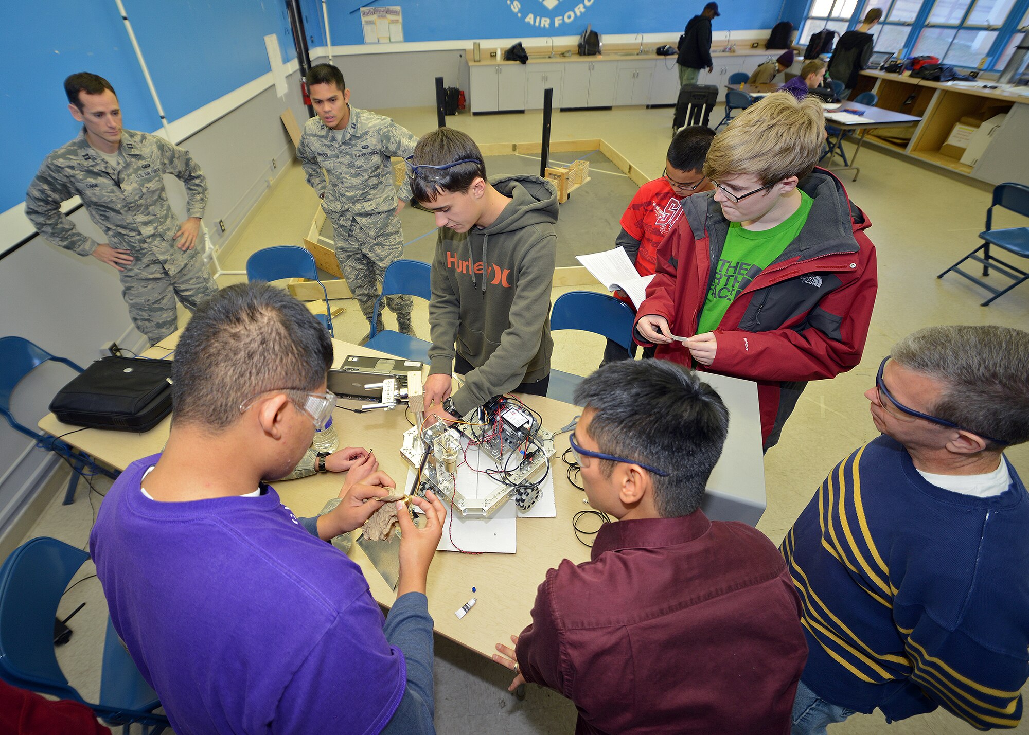 Desert Jr. and Sr. High School students from the DHS Scorpions Robotics Team work on their autonomous robot under the supervision of Edwards military and civilian volunteers in preparation for the FIRST Tech Challenge robotics qualifying competition in Claremont, Calif., Dec. 14. The team went on to win the competition where they will ultimately compete in the regional competition which will be held in Los Angeles Feb. 22, 2014. (U.S. Air Force photo by Jet Fabara)