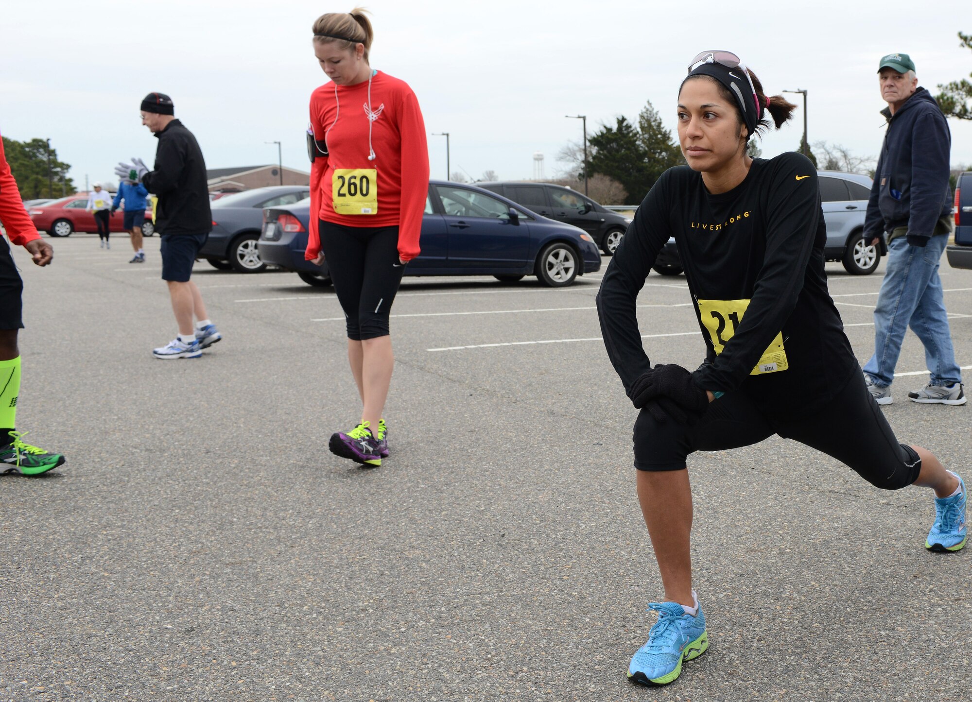 Christina Hogue, spouse of U.S. Air Force Capt. Corey Hogue, stretches before the start of the 4th annual “Race ‘Round the Base” at Langley Air Force Base, Va., Dec. 14, 2013. Hogue finished first in the female category with a time of 1 hour, 6 minutes, 13 seconds. (U.S. Air Force photo by Senior Airman Connor Estes/Released)