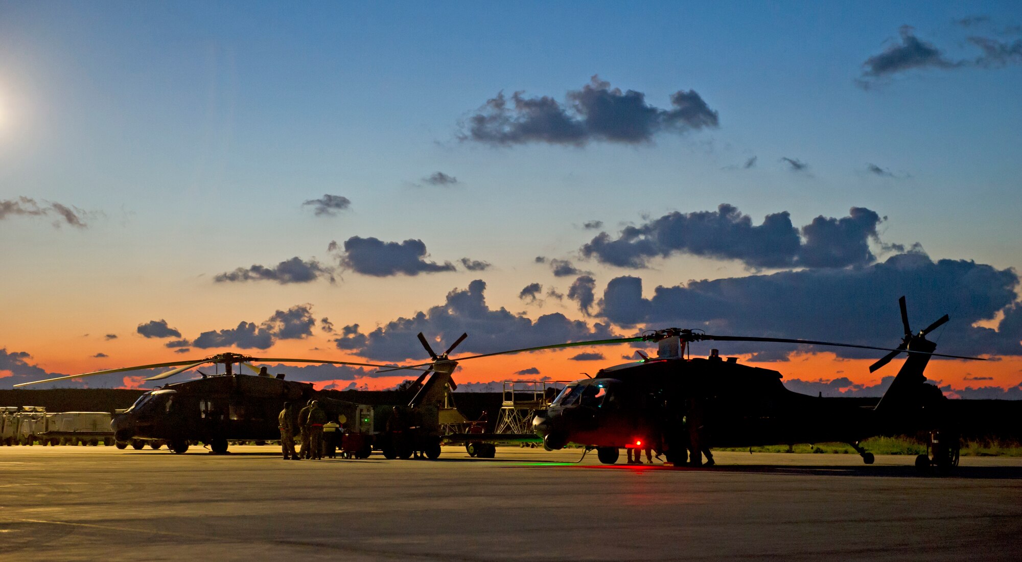 Two HH-60 Pave hawks sit on the flightline in Southern Italy Dec. 16, 2013. The helicopters are deployed to the 693rd Air Expeditionary Group in support of U.S. Africa Command missions. (U.S. Air Force photo/Tech. Sgt. Benjamin Wilson)