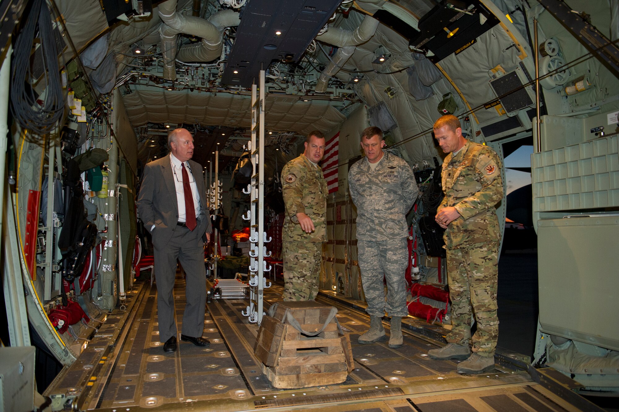 Leadership from the 563rd Air Expeditionary Group briefs General Frank Gorenc, U.S. Air Forces in Europe and Air Forces Africa commander (center), and Douglas Weaver, USAFE-AFAFRICA deputy political advisor (left), on the capabilities of the HC-130J Combat King II deployed to Southern Italy Dec. 16, 2013. The general and Chief Master Sgt. James Davis, USAFE-AFAFRICA command chief, traveled to Italy and Africa to visit Airmen supporting the U.S. Africa Command mission and to address current issues affecting Airmen. (U.S. Air Force photo/Tech. Sgt. Benjamin Wilson)