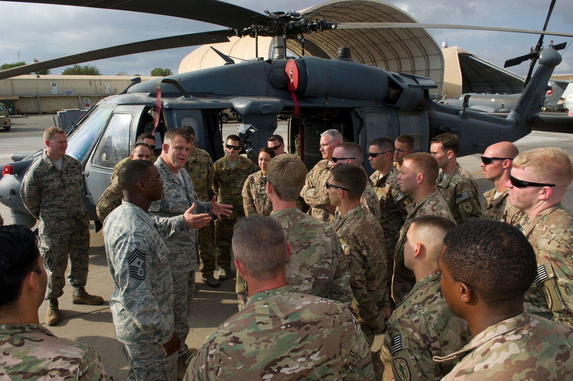 General Frank Gorenc, U.S. Air Forces in Europe and Air Forces Africa commander (right), and Chief Master Sgt. James Davis, USAFE-AFAFRICA command chief, speak with maintainers and crew of an HH-60 Pave Hawk deployed to the 449th Air Expeditionary Group at Camp Lemonier, Djibouti, Dec. 14, 2013. The general and chief traveled to Africa to visit Airmen supporting the U.S. Africa Command mission and to address current issues affecting Airmen. (U.S. Air Force photo/Tech. Sgt. Benjamin Wilson)