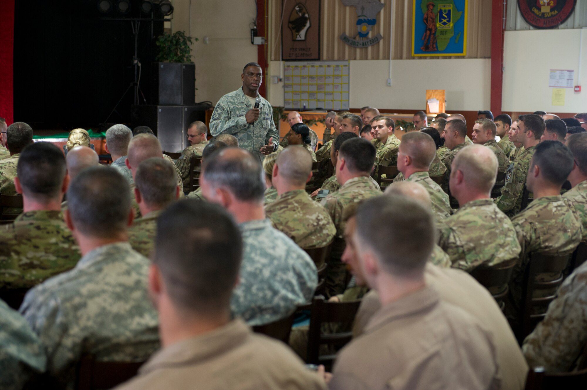 Chief Master Sgt. James Davis, U.S. Air Forces in Europe and Air Forces Africa command chief, addresses Airmen deployed to Camp Lemonier, Djibouti, during an all call Dec. 14, 2013. The chief and General Frank Gorenc, USAFE-AFAFRICA commander, traveled to Africa to visit Airmen supporting the U.S. Africa Command mission and to address current issues affecting Airmen. (U.S. Air Force photo/Tech. Sgt. Benjamin Wilson)