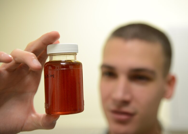 Airman 1st Class David Bednara, 31st Aerospace Medicine Squadron bioenvironmental engineering journeyman, inspects drinking water that tested positive for minerals and unsafe chemicals, Dec. 17, 2013, at Aviano Air Base, Italy. Also known as BEE, the flight ensures Airmen’s safety by identifying workplace hazards to allow for the production of mandated policies in the interest of health and preventative medicine. (U.S. Air Force photo/Airman Ryan Conroy) 