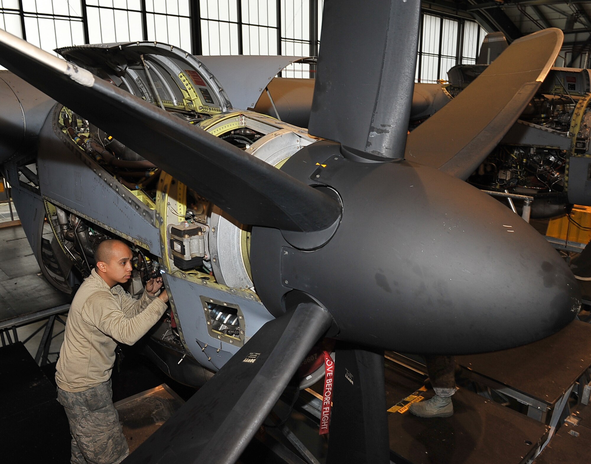 Senior Airman Jonathan Deguzman, 86th Maintenance Squadron aerospace systems technician, inspects a C-130J Super Hercules propeller engine, Dec. 11, 2013, Ramstein Air Base, Germany. Airmen with the 86th Aircraft Maintenance Squadron and 86th MXS work around the clock to ensure the readiness of the aircraft here. (U.S. Air Force photo/Airman Dymekre Allen)