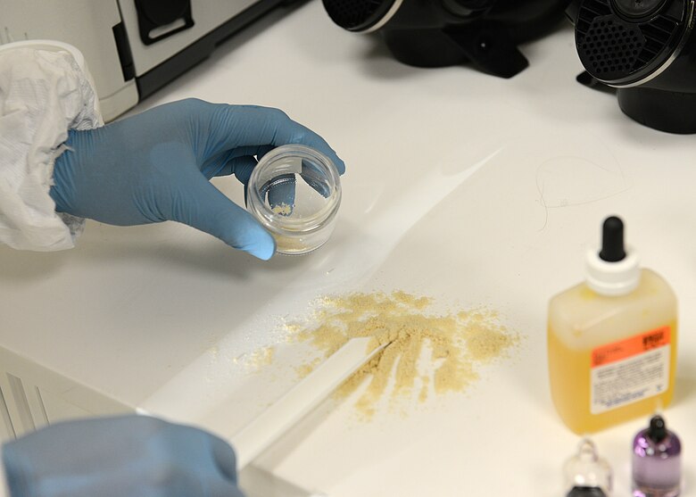 Staff Sgt. Paolo Melendez, 31st Aerospace Medicine Squadron bioenvironmental engineering radiation protection safety manager, tests an unknown powder during a training exercise, Dec. 17, 2013, at Aviano Air Base, Italy. At bioenvironmental engineering, Airmen take measures to prevent four different base-hazard elements: Industrial hygiene, radiation protection, environmental protection and occupational health. (U.S. Air Force photo/Airman Ryan Conroy)   
