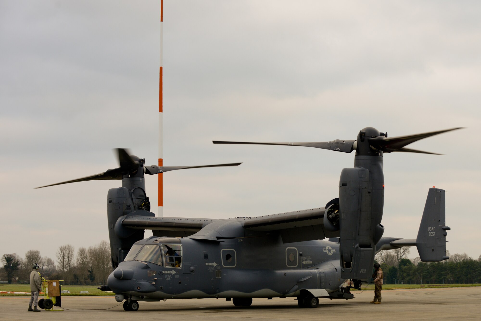 RAF FAIRFORD, United Kingdom – Senior Airman Amber Young, 352nd Special Operations Group Maintenance crew chief, watches a CV-22 as the pilot conducts tests before taking off during a logistics exercise at RAF Fairford Dec. 10. RAF Fairford opened its gates to more than 130 Airmen and three MC-130Js in addition to the CV-22s so the 352nd SOG could conduct a logistics exercise with their new airframes Dec. 9 to 12. (U.S. Air Force photo by Tech. Sgt. Chrissy Best)