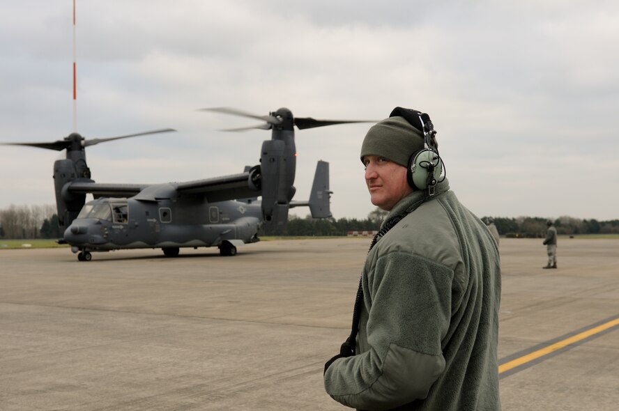 RAF FAIRFORD, United Kingdom – Tech. Sgt. Timothy Pickett, 352nd Special Operations Group Maintenance crew chief, looks around as a CV-22 prepares to take off during a logistics exercise at RAF Fairford Dec. 10. RAF Fairford opened its gates to more than 130 Airmen and three MC-130Js in addition to the CV-22s so the 352nd SOG could conduct a logistics exercise with their new airframes Dec. 9 to 12. (U.S. Air Force photo by Tech. Sgt. Chrissy Best)