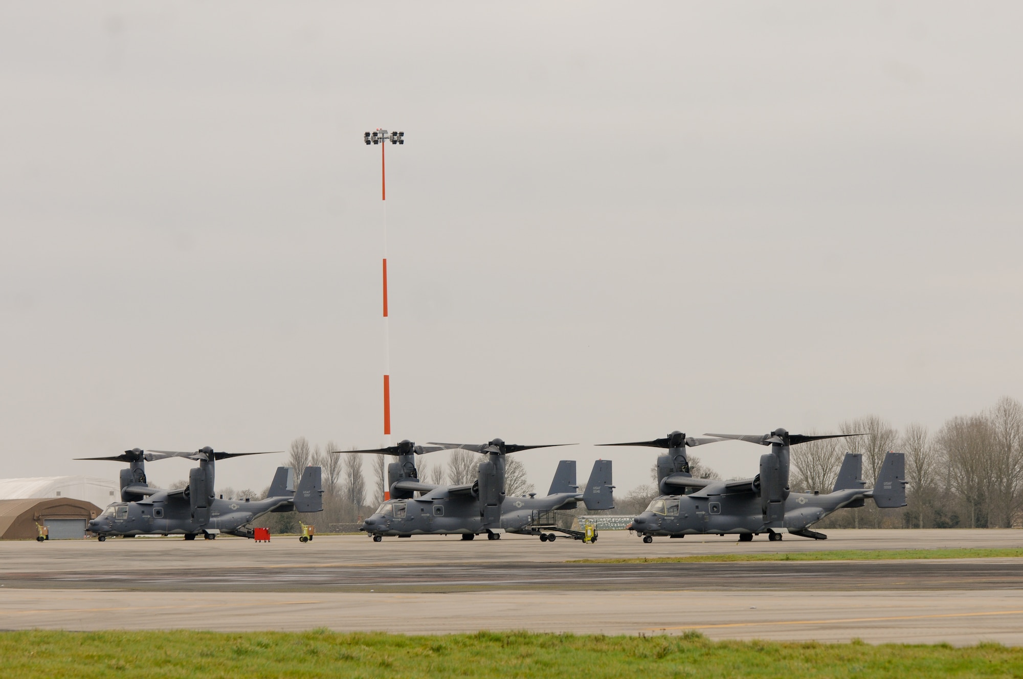 RAF FAIRFORD, United Kingdom - Three CV-22s from the 352nd Special Operations Group at RAF Mildenhall sit on the ramp at RAF Fairford Dec. 10. RAF Fairford opened its gates to more than 130 Airmen and three MC-130Js in addition to the CV-22s so the 352nd SOG could conduct a logistics exercise with their new airframes Dec. 9 to 12. (U.S. Air Force photo by Tech. Sgt. Chrissy Best)