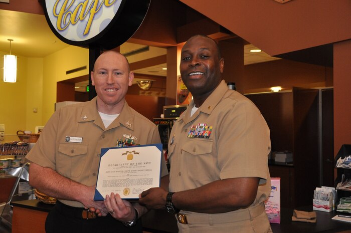 Petty Officer 1st Class Samuel Hutcheson III, a hospital corpsman and Naval Health Clinic Charleston Physical and Occupational Therapy leading petty officer, receives the Navy and Marine Corps Achievement Medal from Capt. Marvin Jones, NHCC commanding officer, during a morning colors ceremony Dec. 6, 2013, at NHCC. Hutcheson was recently named NHCC’s 2013 Sailor of the Year. (U.S. Navy photo/Kris Patterson)