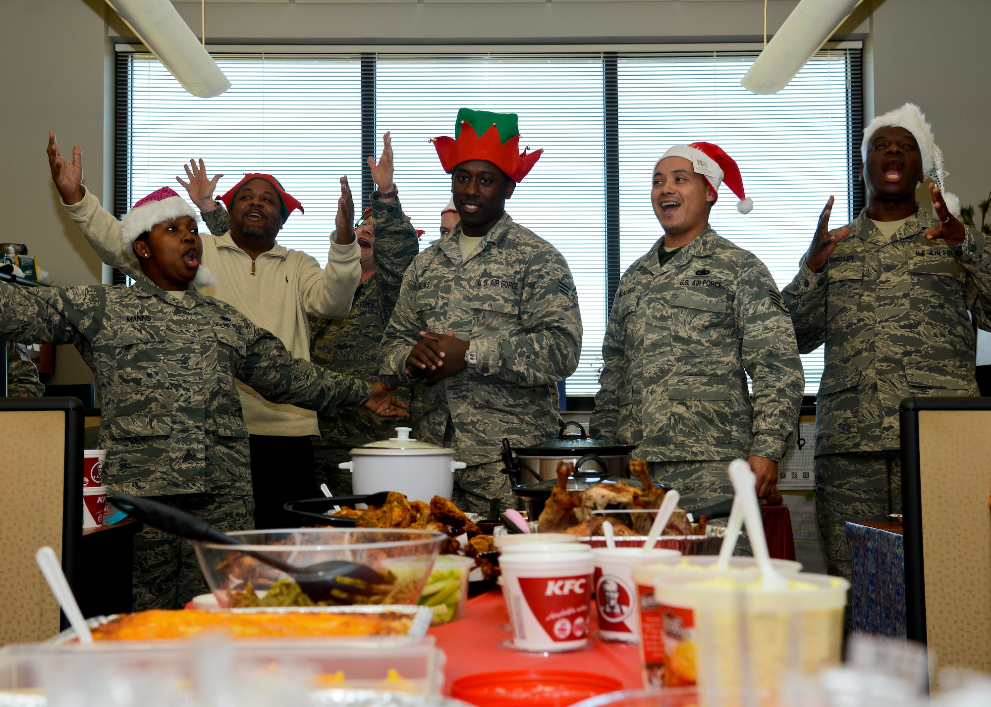 The runners-up of the 439th Supply Chain Operations Squadron's canned food drive, who raised 561 canned goods, sings “Jingle Bells” to the flight while dressed in holiday costumes at Langley Air Force Base, Va., Dec 13, 2013. Proceeds from the event benefitted the Eastern Virginia Food Bank in an effort to support local community members for the holiday season. (U.S. Air Force photo by Airman 1st Class Victoria H. Taylor/Released)