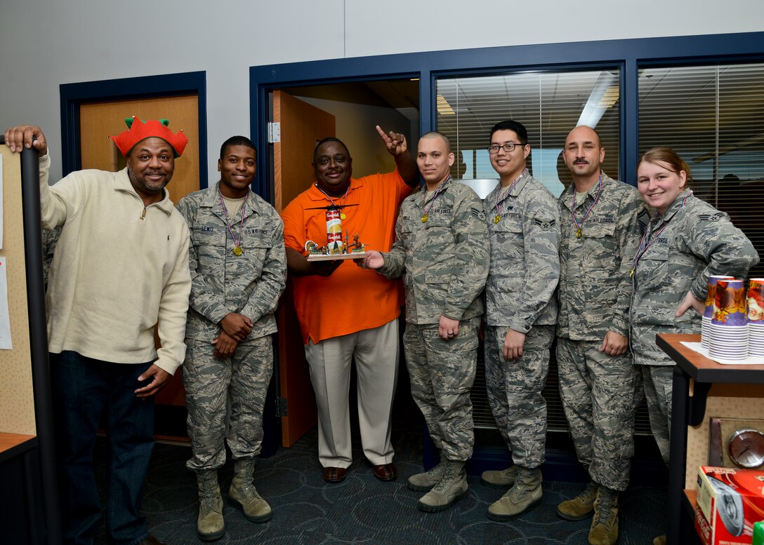 U.S. Air Force Airmen and civilians of the 439th Supply Chain Operations Squadron bomber mission capable flight were recognized for collecting the most canned goods during their 30-day food drive challenge at Langley Air Force Base, Va., Dec. 13, 2013. The team collected 949 cans to support the Eastern Virginia Food Bank. (U.S. Air Force photo by Airman 1st Class Victoria H. Taylor/Released)