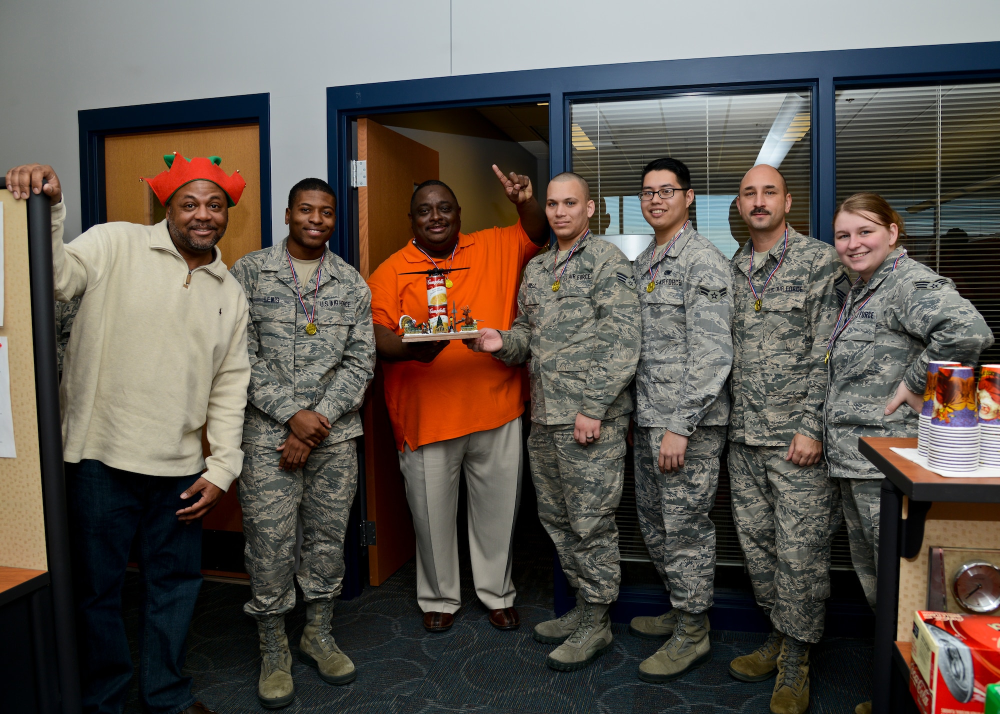U.S. Air Force Airmen and civilians of the 439th Supply Chain Operations Squadron bomber mission capable flight were recognized for collecting the most canned goods during their 30-day food drive challenge at Langley Air Force Base, Va., Dec. 13, 2013. The team collected 949 cans to support the Eastern Virginia Food Bank. (U.S. Air Force photo by Airman 1st Class Victoria H. Taylor/Released)