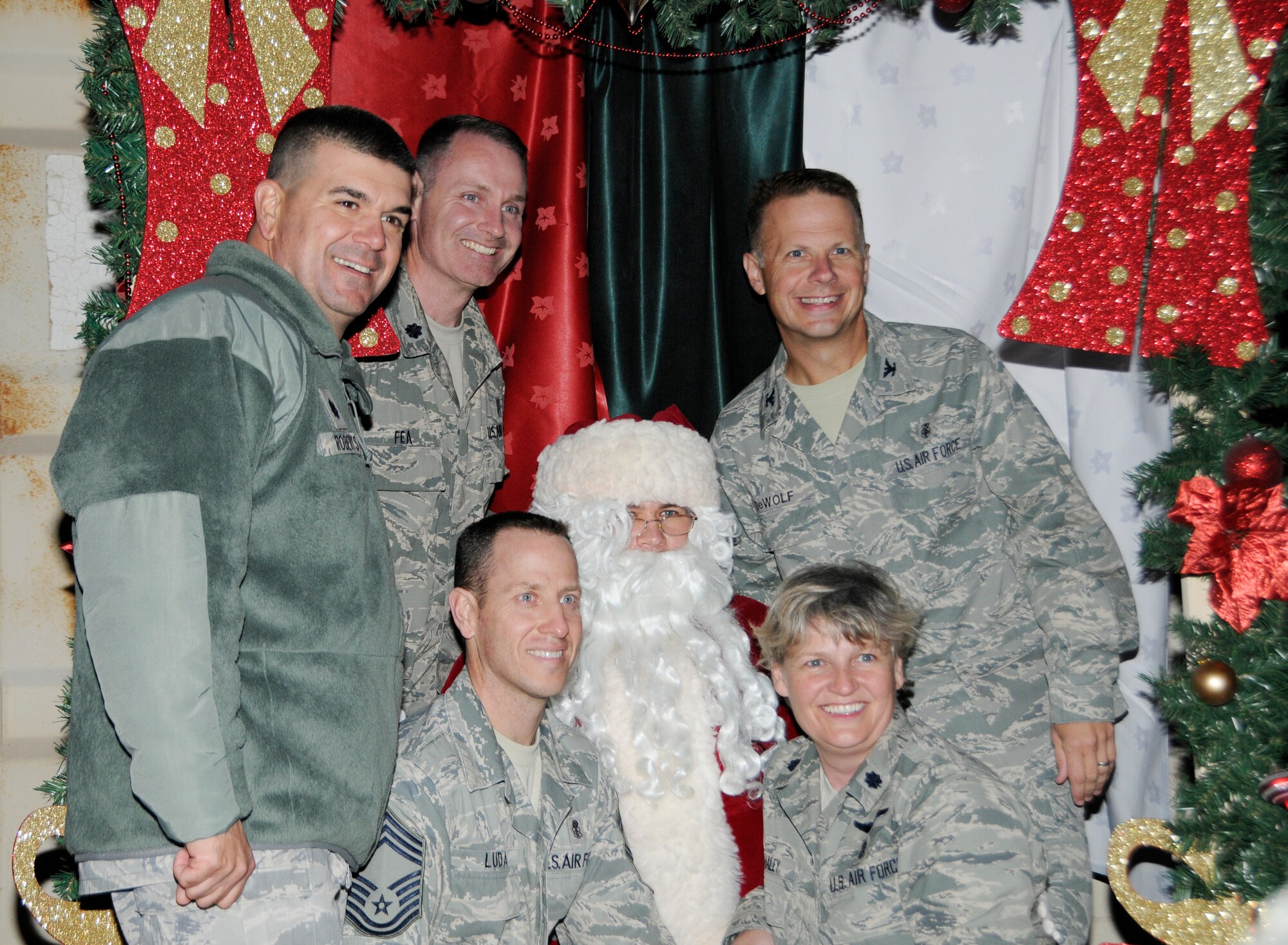 Santa Claus poses with deployed Airmen at the 379th Air Expeditionary Wing in Southwest Asia, Dec. 16, 2013. Santa made a surprise visit to spread the Christmas cheer to deployed members at the 379th AEW. (U.S. Air Force photo/Senior Airman Hannah Landeros)