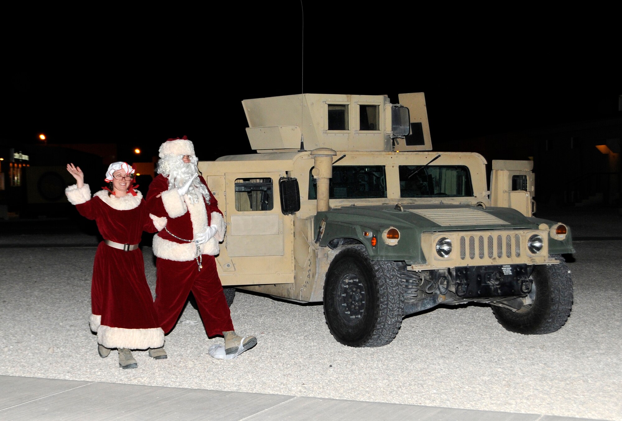 Santa and Mrs. Claus bring Christmas cheer to the 379th Air Expeditionary Wing during the Christmas tree lighting celebration in Southwest Asia, Dec. 16, 2013. Santa and Mrs. Claus spent the evening talking with and taking photos with deployed members and their families. (U.S. Air Force photo/Senior Airman Hannah Landeros)