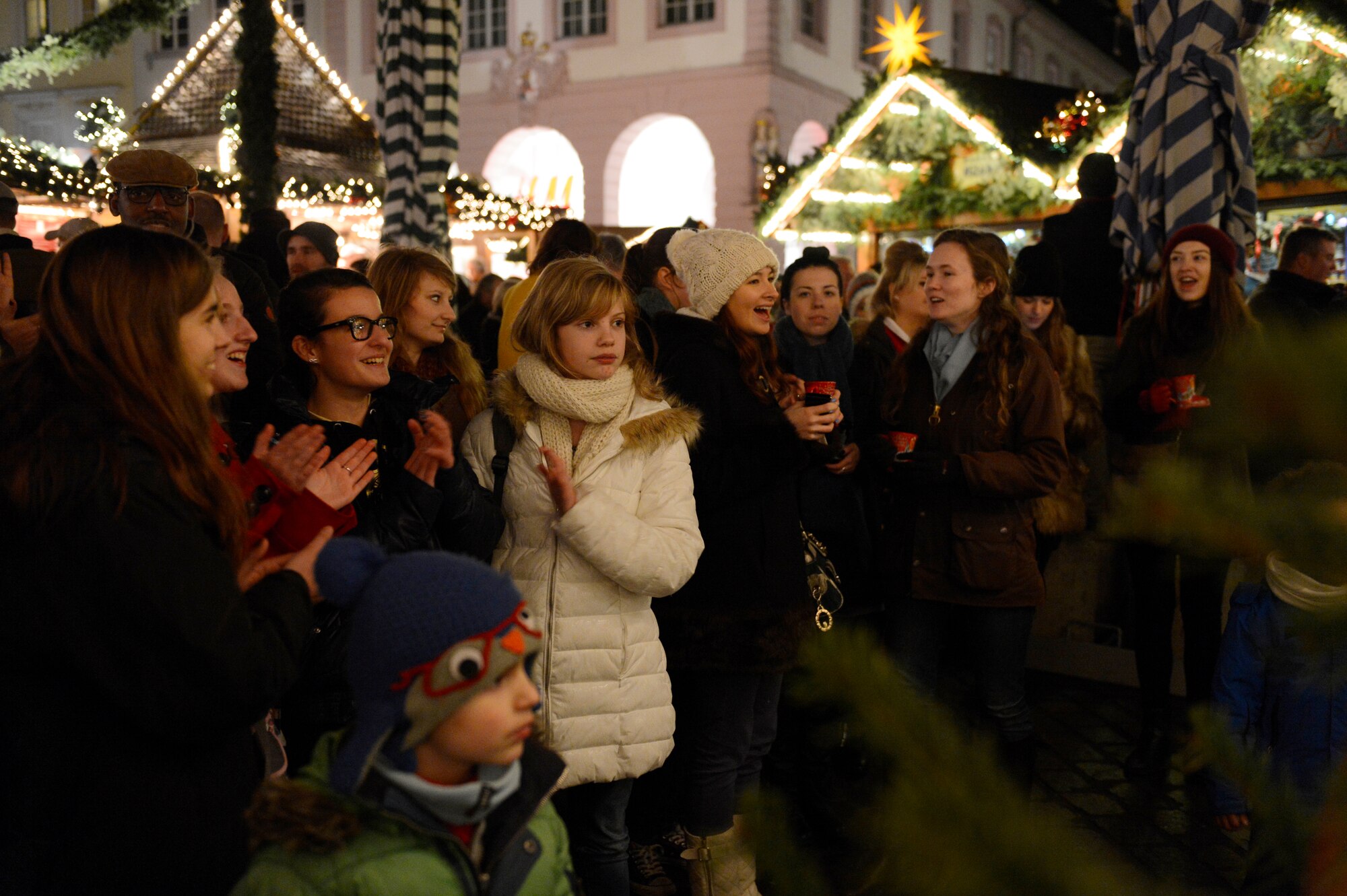 TRIER, Germany — A crowd applauds after a holiday musical performance by the U.S. Air Forces in Europe Band’s Five Star Brass ensemble at a Weihnachtsmarkt Dec. 17, 2013. The Trier Weihnachtsmarkt, or Christmas market, is one of many holiday markets hosted in Germany annually. (U.S. Air Force photo by Staff Sgt. Christopher Ruano/Released)
