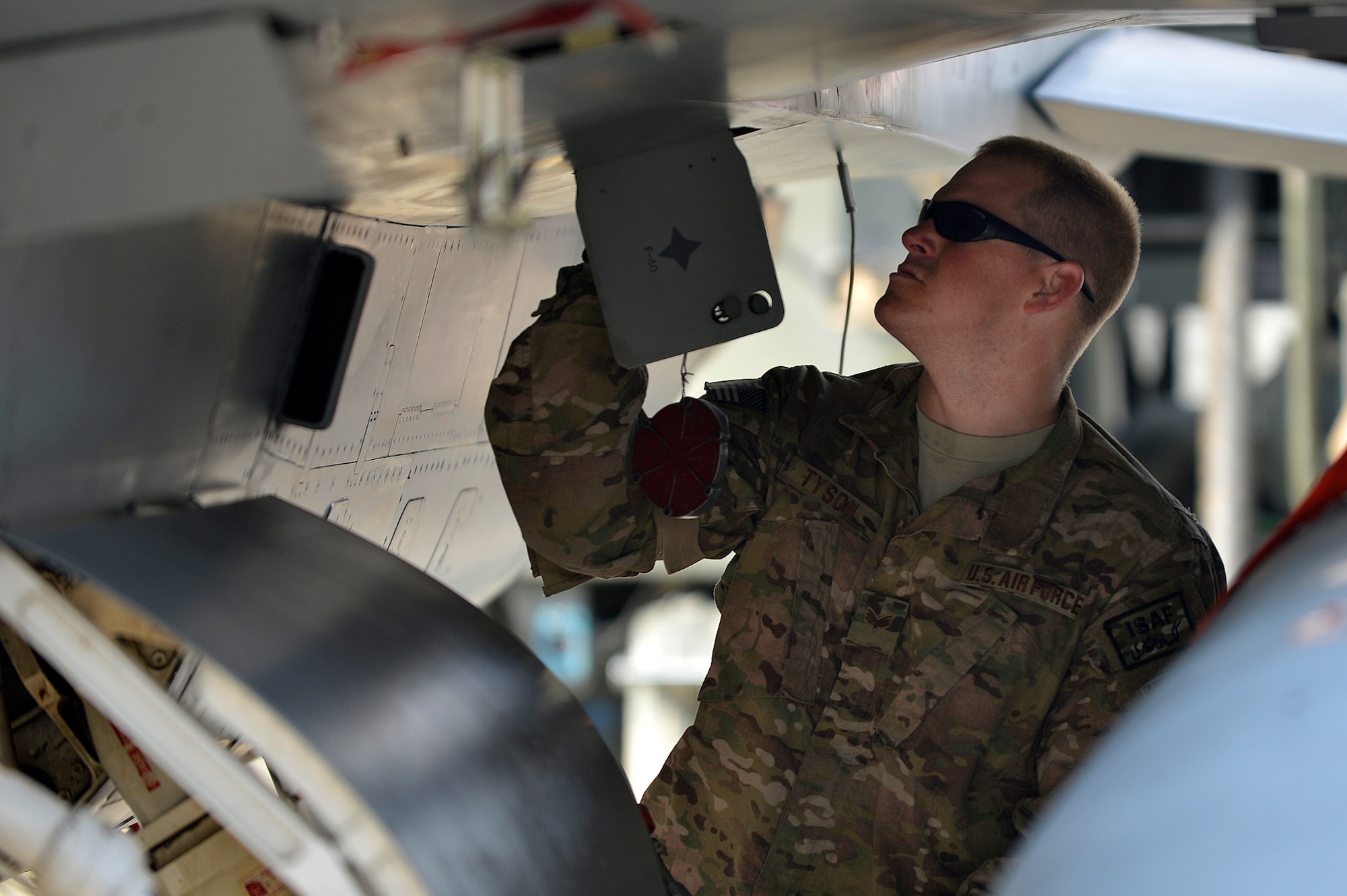 An Airman does post-flight maintenance on a F-16 Fighting Falcon at Bagram Airfield, Afghanistan, Dec. 15, 2013. The F-16s transitioned from Kandahar Airfield, Afghanistan, to Bagram once the main runway was renovated. (U.S. Air Force photo by Senior Airman Kayla Newman/Released)