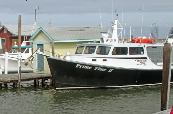 A waterman's workboat sits docked in Tangier Harbor. The federal navigation channel allows vessels like this safe passage between the Chesapeake Bay and the town's harbor. (U.S. Army photo/Kerry Solan)