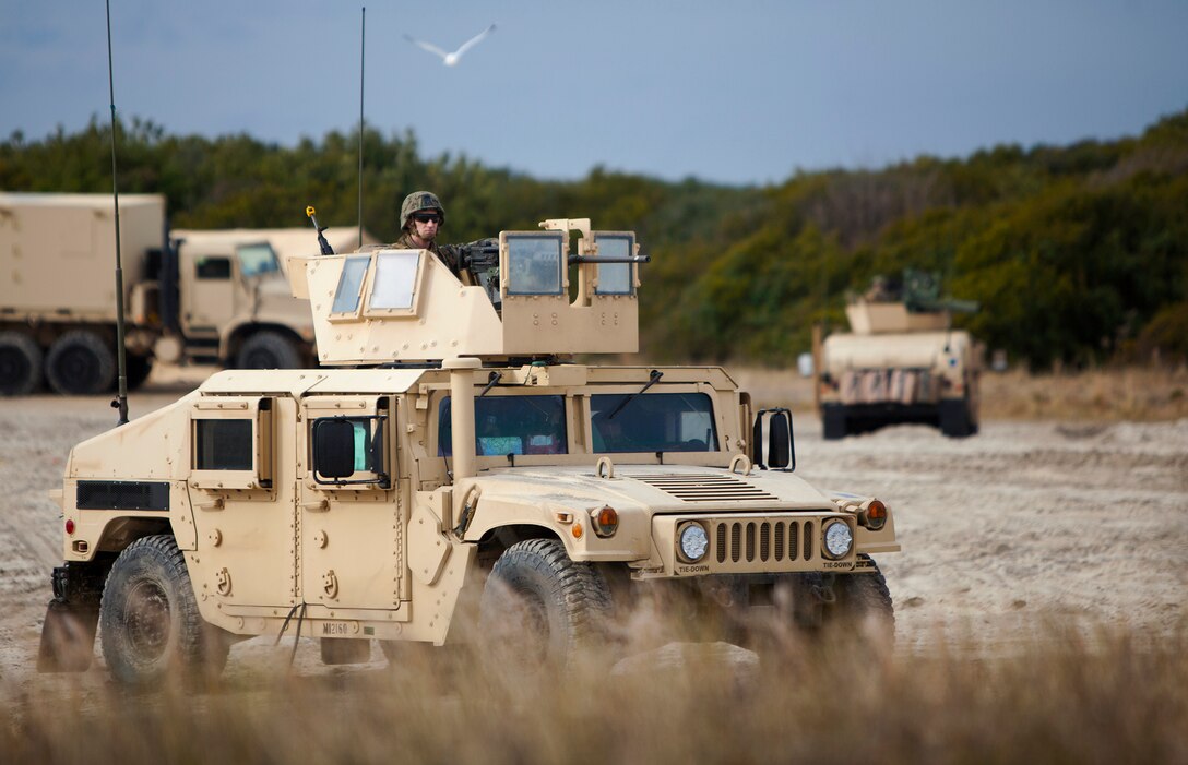 U.S. Marines with Battalion Landing Team 1st Battalion, 6th Marine Regiment, 22nd Marine Expeditionary Unit (MEU), hold security in a Humvee during an amphibious assault at Marine Corps Base Camp Lejeune, N.C., Dec. 14, 2013. The MEU recently completed the Composite Training Unit Exercise in preparation for its scheduled 2014 deployment to the U.S. 5th and 6th Fleet areas of responsibility with the Bataan Amphibious Ready Group as a sea-based, expeditionary crisis response force capable of conducting amphibious missions across the full range of military operations. (U.S. Marine Corps photo by Lance Cpl. Caleb McDonald/Released)