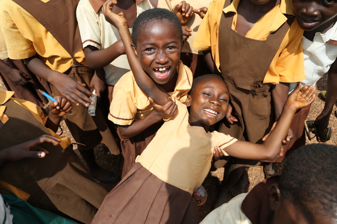 Students pause for a photo near the site of a new junior high school building, housing grades 4-6, in Grumesa, Ghana July 22, 2013. The building, designed to accommodate more than 150 students, features three classrooms, a teachers’ room, storage space and a detached latrine facility. The U.S. Army Corps of Engineers Europe District is working in partnership with U.S. Africa Command and the local embassy to bring the school to fruition. The new classrooms will enable additional students from the district to attend school in Grumesa. The project, valued at $208,700 dollars, features local building materials including mahogany doors and decorative cement blocks, hand selected by the school headmaster. In addition, local masons, painters and other workers were hired as subcontractors. The Ghanaian subcontractors credit U.S. partners, and contractor, Dover Vantage, for their newly acquired knowledge of U.S. building and safety practices. 