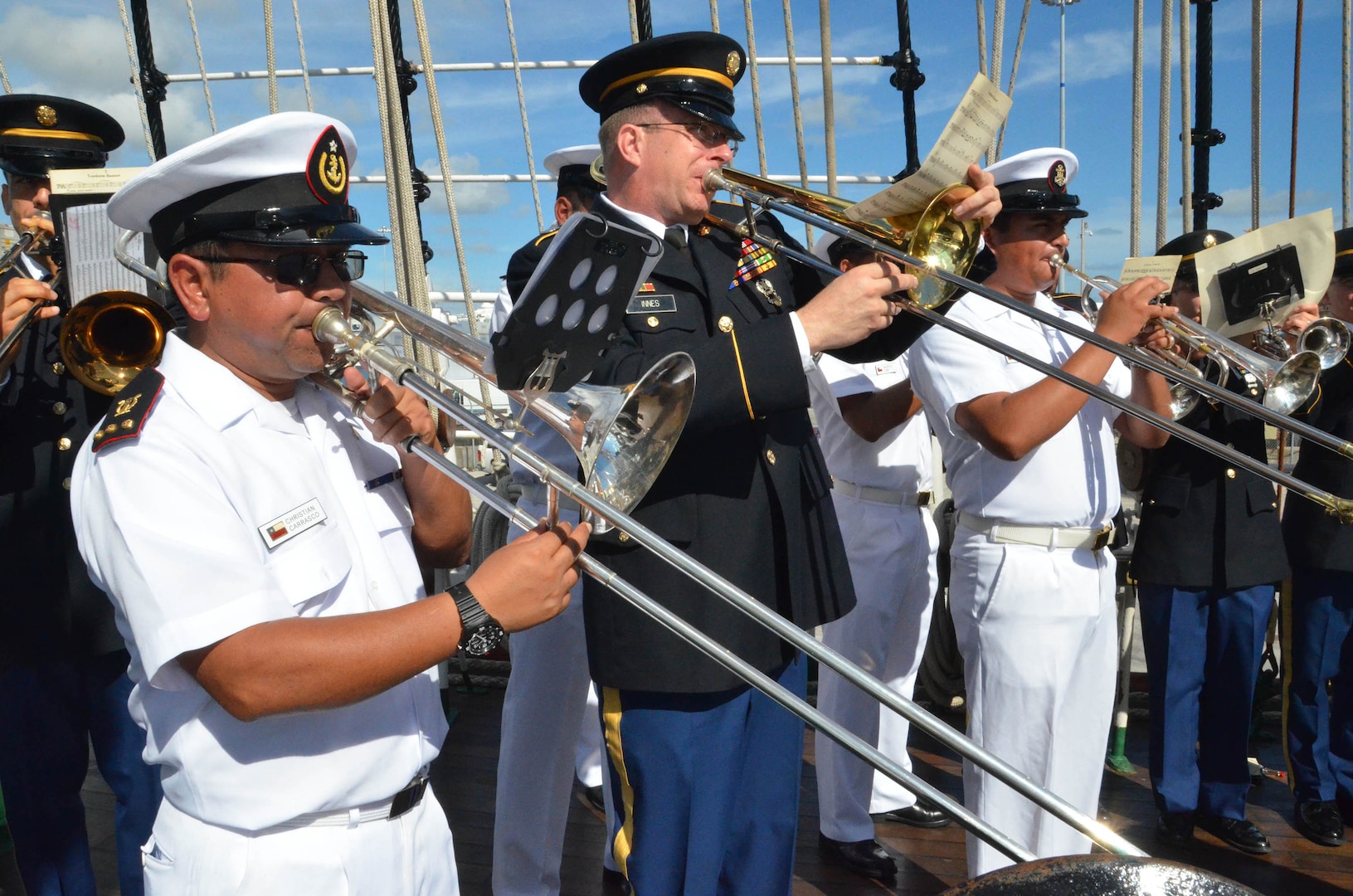 Soldiers from the Florida Army National Guard's 13th Army Band play with members of the Chilean military band during a subject matter exchange on board the Chilean ship Esmeralda at the Port of Miami, Dec. 4, 2013. Both bands played military music from each other's nations during the day-long exchange.