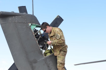 Army Sgt. Tiara Carr, an AH-64 Apache helicopter maintainer with the Missouri Army National Guard's Company C, 1st Battalion, 135th Aviation Regiment (Attack Reconnaissance) inspects the tail rotor gear box while performing a 25-hour inspection on an Apache helicopter, Nov. 5, 2013. The 135th Aviation Regiment maintainers immediately perform inspections upon an Apache landing to provide the maximum time to fix any problems on the aircraft since last leaving the ground.