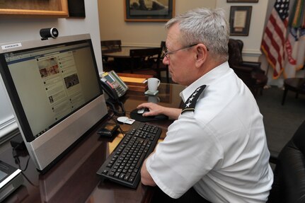 Army Gen. Frank Grass, the chief of the National Guard Bureau, surfs his official Facebook page at the Pentagon, Arlington, Va., Nov. 19, 2013