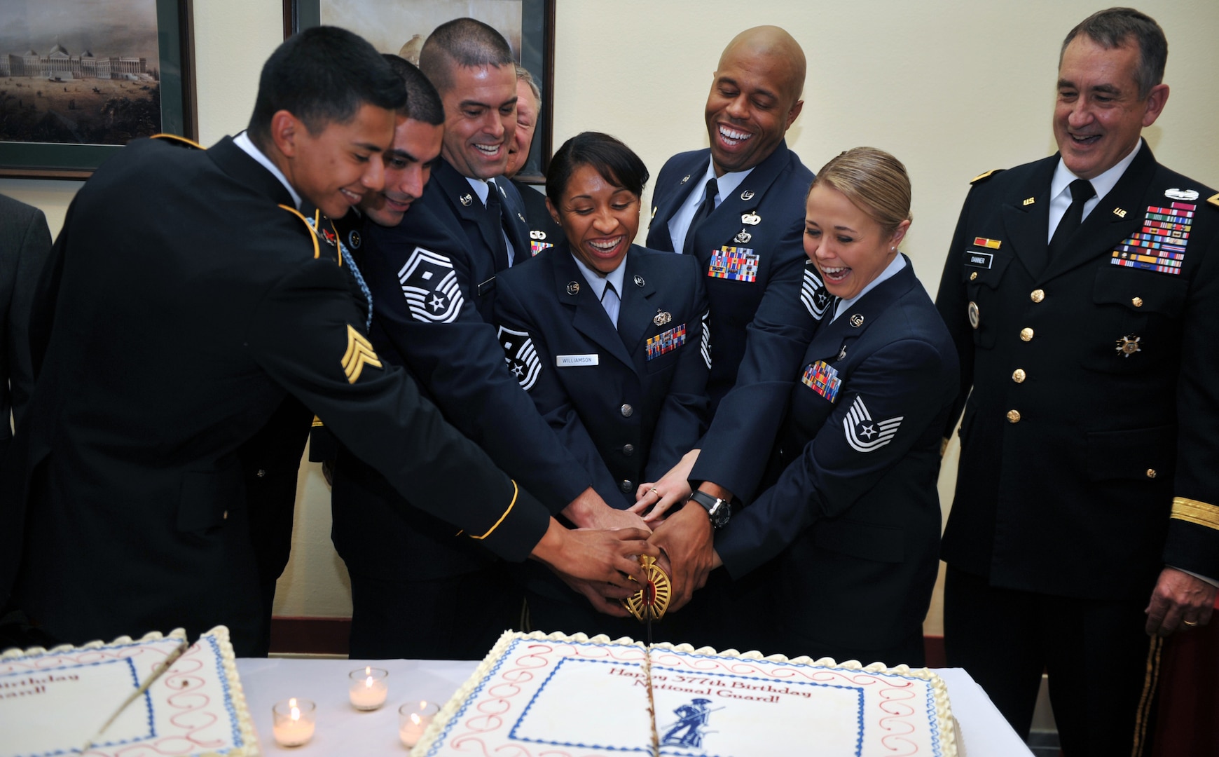 Six of the National Guard's eight 2013 Outstanding Soldiers and Airmen of the Year kick off the National Guard's 377th birthday celebrations by cutting a cake on Capitol Hill, Washington, D.C., Dec. 11, 2013. The birthday is on Dec. 13th.