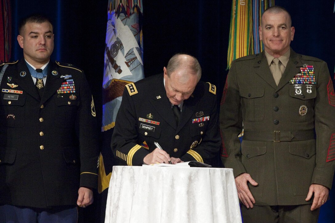 Gen. Martin Dempsey, the 18th Chairman of the Joint Chiefs of Staff, and Sgt. Maj. Bryan B. Battaglia, the 2nd Senior Enlisted Advisor to the Chairman of the Joint Chiefs of Staff, hosts a book release for “The Noncomissioned Officer and Petty Officer Backbone of the Armed Forces” at the Pentagon in Washington, D.C., on Dec. 17, 2013. (U.S. Marine Corps photo by Lance Cpl. Alejandro Gomez)
