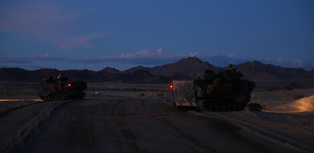 Assault amphibious vehicles provide security during a mechanized raid in support of Exercise Steel Knight 2014 at Marine Corps Air Ground Combat Center Twentynine Palms, Calif., Dec. 13, 2013. The assault utilized both air and ground elements to eliminate their objective. Steel Knight is an annual exercise that includes elements from the entire I Marine Expeditionary Force (MEF). The exercise focuses on conventional operations and provides realistic training that prepares Marines for overseas operations. (U.S. Marine Corps photo by Cpl. James Gulliver/Released)