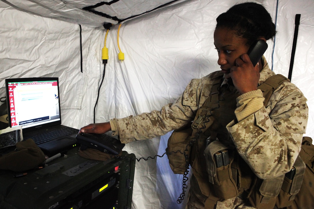 Sgt. Ebony Tatum, telecommunications supervisor, Headquarters Company, Combat Logistics Regiment 1, 1st Marine Logistics Group, ensures a telephone works correctly aboard Marine Corps Air Ground Combat Center Twentynine Palms, Calif., during Exercise Steel Knight 14. The telecommunication, data and radio Marines worked together to get communication up in only one day. Exercise Steel Knight 2014, which took place Dec. 9-16, is an annual exercise designed to prepare the 1st Marine Division for deployment with the Marine Air-Ground Task Force as the Ground Combat Element with the support of 1st MLG and 3rd Marine Air Wing.