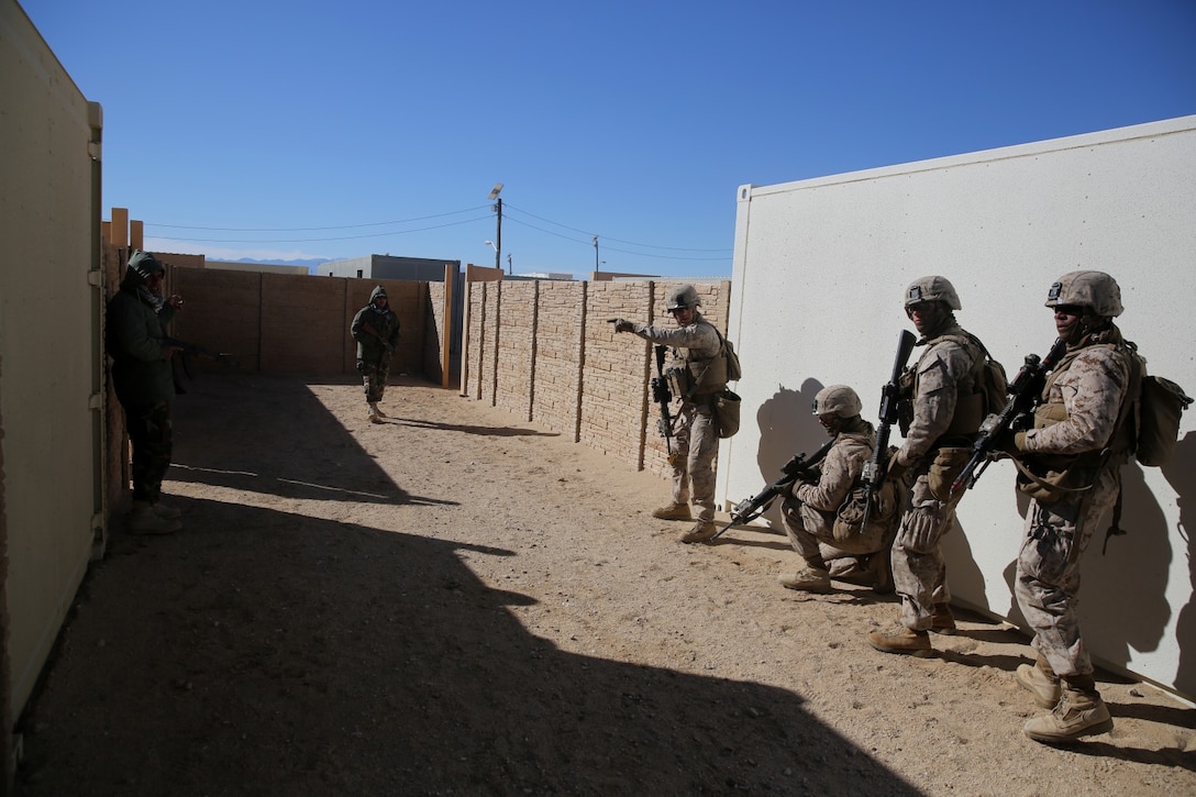 Lance Cpl. Ben Knipp, center, team leader, Bravo Company, 1st Battalion, 7th Marine Regiment, and a native of Englewood, Ohio, prepares his team to breach a compound during a counterinsurgency exercise on Range 220 at Marine Corps Air Ground Combat Center Twentynine Palms, Calif., Dec. 9, 2013. The $140 million urban warfare training facility consists of more than 1,000 buildings and is divided into four sectors. The buildings replicate what can be found in an urban town to include gas stations, factories, one story complexes, marketplaces and multiple story buildings. The battalion is slated to continue a vigorous training schedule before deploying to Afghanistan this spring.