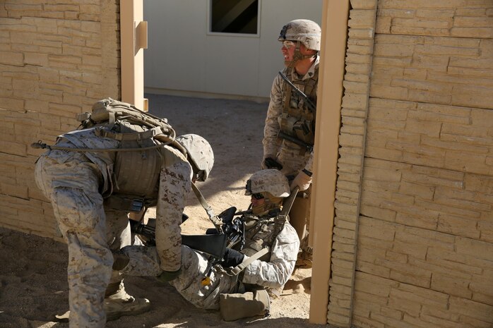 Marines with Bravo Company, 1st Battalion, 7th Marine Regiment, evacuate a simulated casualty during a counterinsurgency exercise on Range 220 at Marine Corps Air Ground Combat Center Twentynine Palms, Calif., Dec. 9, 2013. The $140 million urban warfare training facility consists of more than 1,000 buildings and is divided into four sectors. The buildings replicate what can be found in an urban town to include gas stations, factories, one story complexes, marketplaces and multiple story buildings. The battalion is slated to continue a vigorous training schedule before deploying to Afghanistan this spring.