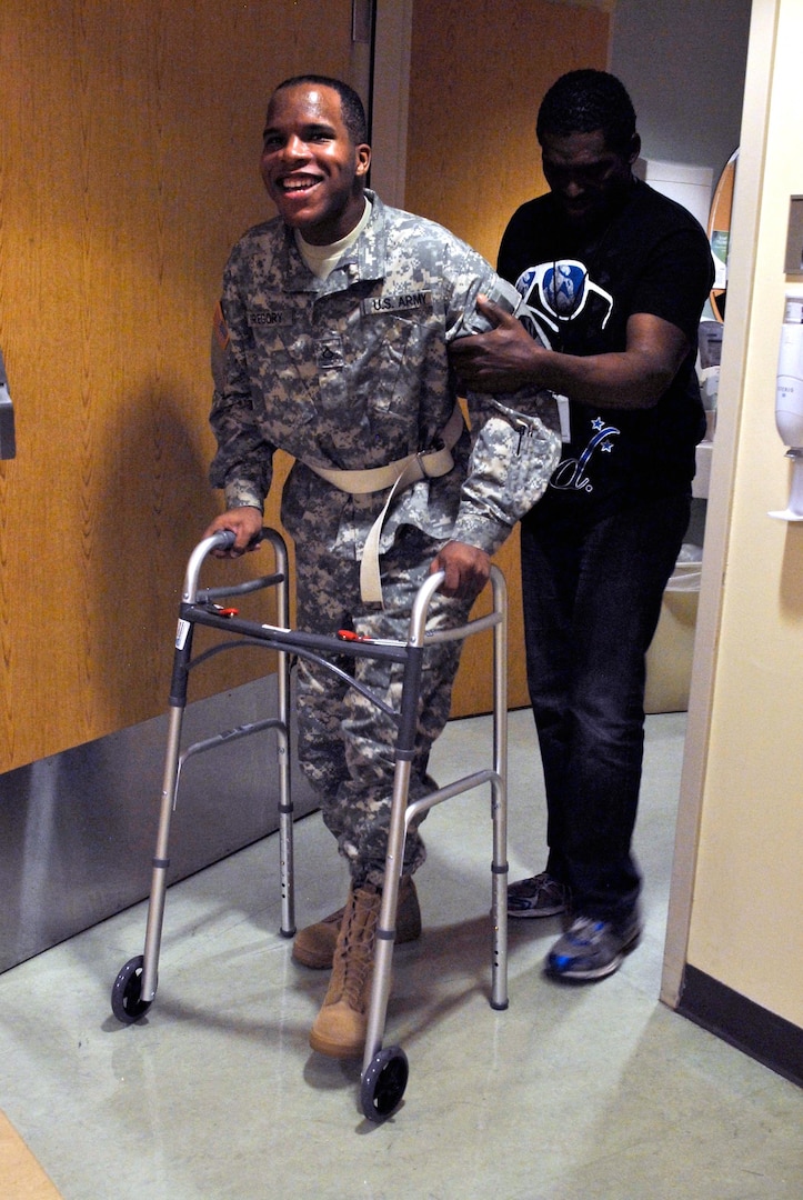 Army Spc. Rashaad Gregory, an air conditioning and refrigeration repairer with the Arizona Army National Guard's 3666th Support Maintenance Company, leaves his room at St. Joseph's Hospital and Medical Center in Phoenix, Nov. 15, 2013. Injured in a car accident in July, Gregory suffered an internal decapitation, which typically results in death or paralysis, but was able to walk out of the hospital with help from his father and a walker.