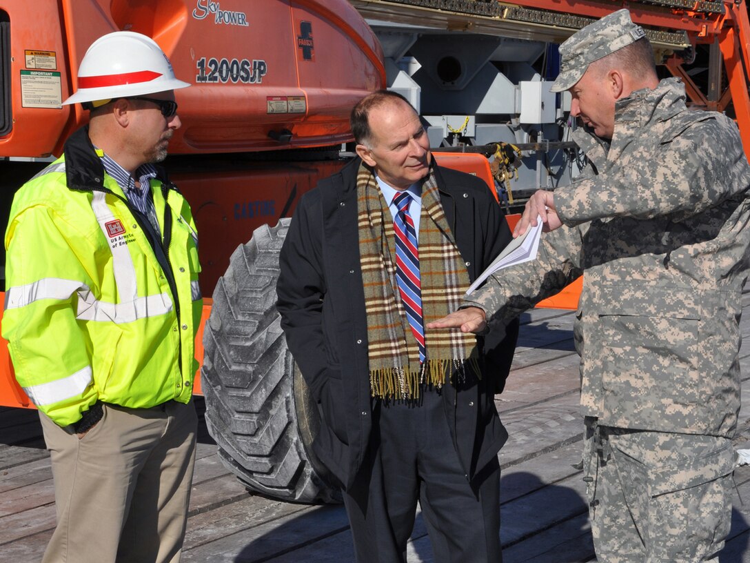 Louisville District Commander Col. Luke Leonard briefs Cong. Bill Enyart Dec. 18, 2013, during the Illinois 12th District representative's first visit to the Olmsted Locks and Dam construction project. The tour of the casting yard and control tower was led by Deputy Olmsted Division Chief Mick Awbrey (left).  