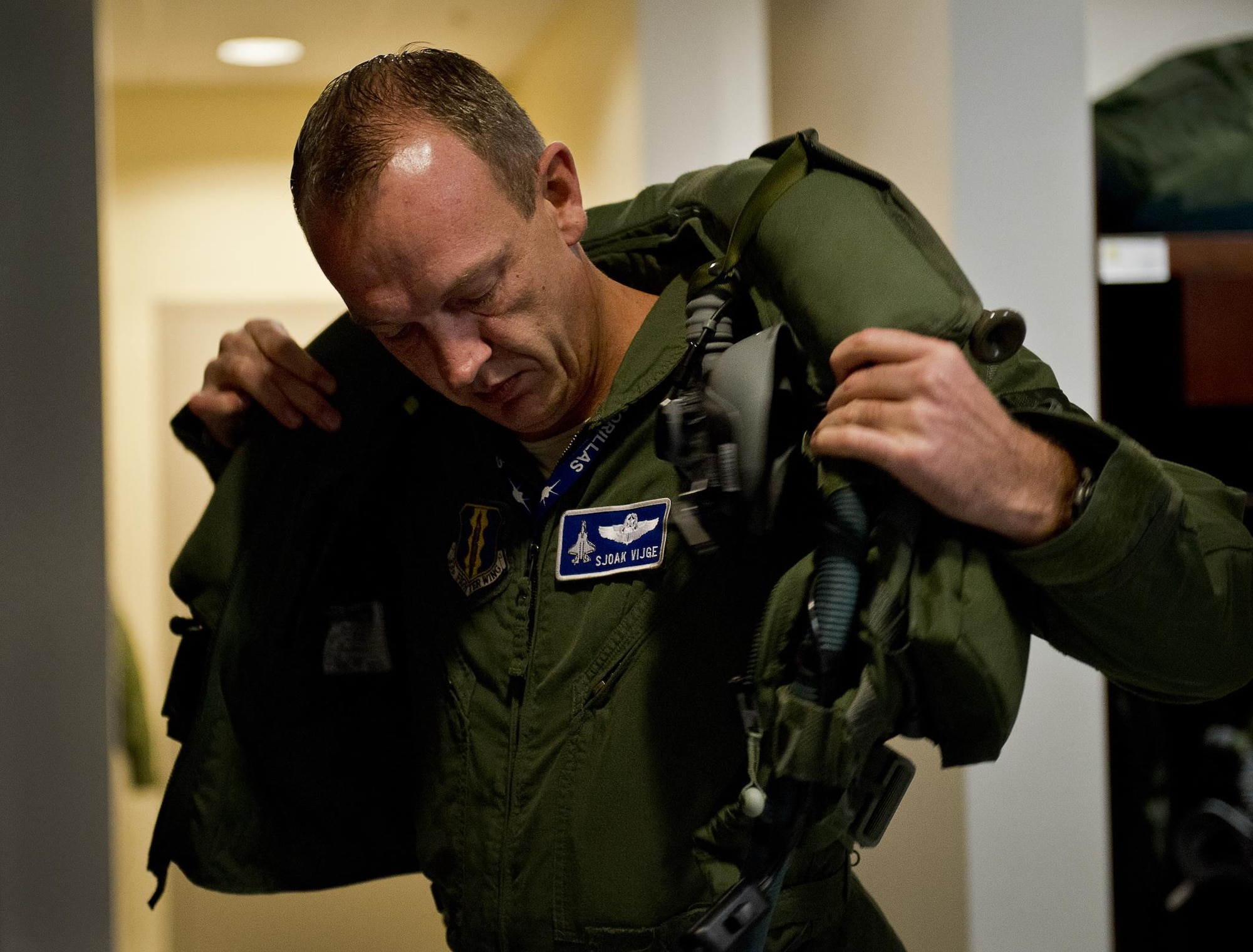 Maj. Laurens Vijge, a Royal Netherlands Air Force pilot, makes adjustments while in the seat of an F-35A Lightning II prior to his first flight in the aircraft Dec. 18 at Eglin Air Force Base, Fla. Vijge became the Royal Netherlands Air Force F-35 Integrated Training Center training lead, completed his first flight after 210 hours of classroom training and 13 flights in the simulators (U.S. Air Force photo/Samuel King Jr.) 