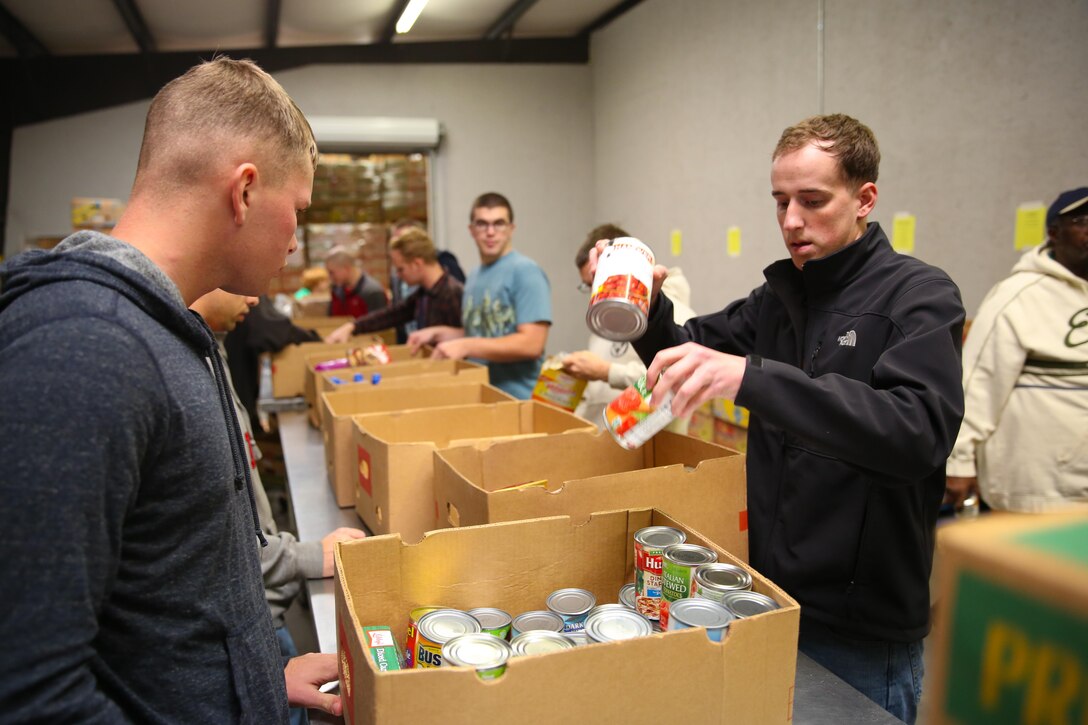 Marines and sailors with 3rd Battalion, 6th Marine Regiment, unpack and organize food during a community relations project with the Food Bank of Central and Eastern North Carolina, in Greenville, N.C., December 17, 2013. “It was turned into a competition of who can break the boxes down and get the boxes sorted the fastest,” said Navy Lt. Reginald E. Jones, the 3rd Battalion, 6th Marine Regiment chaplain, and native of DeSoto, Texas. “We were packing so fast that they wanted us to go to lunch so they can catch up. We probably did a week’s worth of work in only a few hours.”