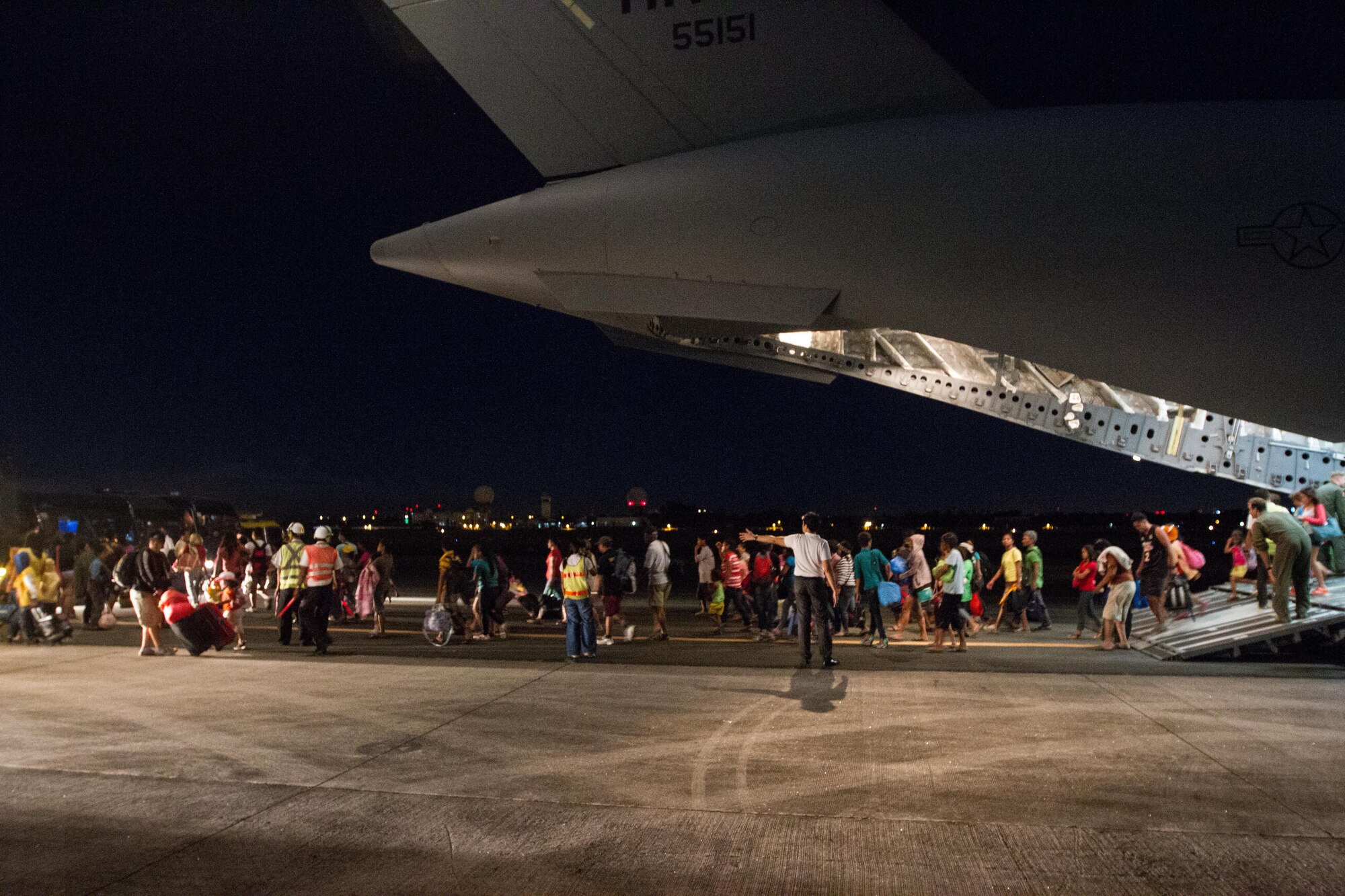 Displaced residents from Tacloban, Philippines, exit a C-17 Globemaster III after being evacuated to Manila Nov. 17, 2013 during Operation Damayan. The aircrew, deployed from Joint Base Pearl Harbor-Hickam, Hawaii, aided in the successful rescue of 1,177 evacuees while flying humanitarian missions in support of humanitarian assistance and disaster relief effort following Super Typhoon Haiyan. The 535th Airlift Squadron C-17 is one of two deployed to the region. (U.S. Air Force Photo/Staff Sgt. Ramon Brockington)