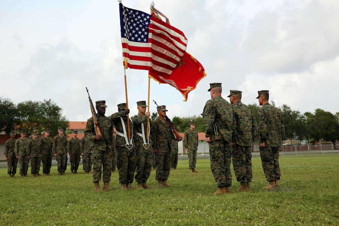 Colonel Augustin Bolanio (center), the commanding officer of the 4th Civil Affairs Group, Sgt. Maj. Mark Davis (left), and Lt. Col. Jeremy Chio (right), stand at attention after uncasing the unit battle colors during the reactivation ceremony of the 4th CAG Dec. 15.  The Marines hosted community members and distinguished visitors during a re-activation ceremony that marked the official standing up of the first Marine Corps civil affairs group in South Florida.  The civil affairs group will be the conduit between the U.S. military forces and civilian authorities, local population and non-governmental organizations and will conduct civil military activities to enhance the relationship with host nation personnel and publics.