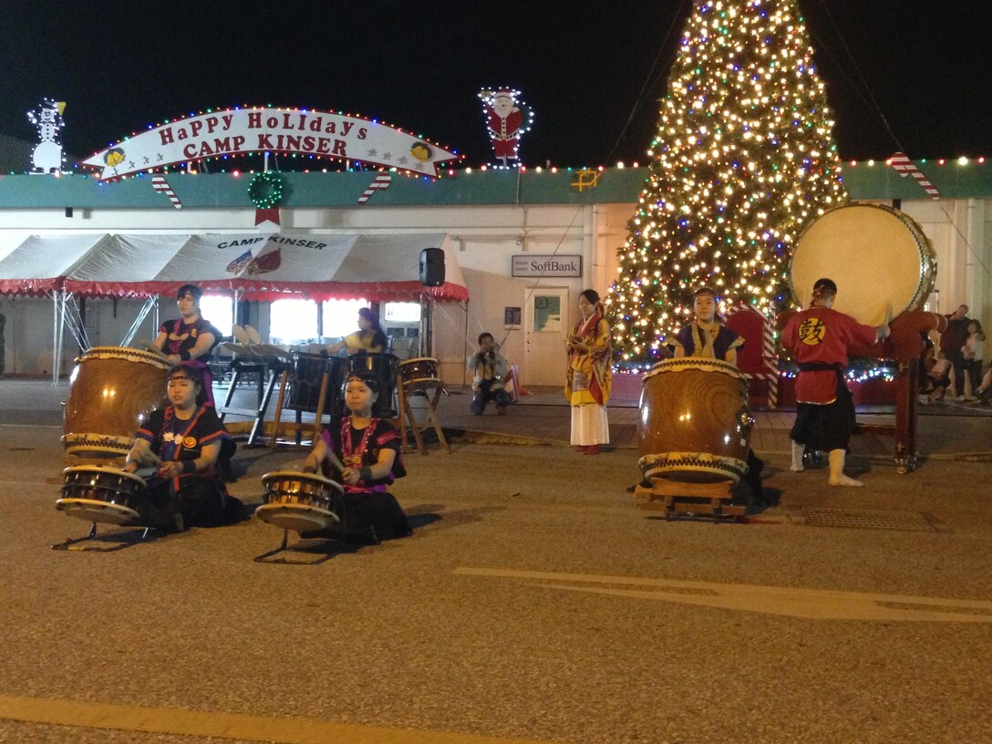 Waka Tida Taiko Drummers perform and dance for members of the military community and Japanese citizens during the 7th annual holiday tree lighting Dec. 6 at the Camp Kinser Main Exchange. “This tree lighting ceremony represents a lot of things. No matter what religion, faith or whatever you believe in, tonight that tree represents peace, love and good will to everyone,” said Col. Edmund J. Bowen, the commanding officer of Camp Kinser and Combat Logistics Regiment 37, 3rd Marine Logistics Group, III Marine Expeditionary Force. 