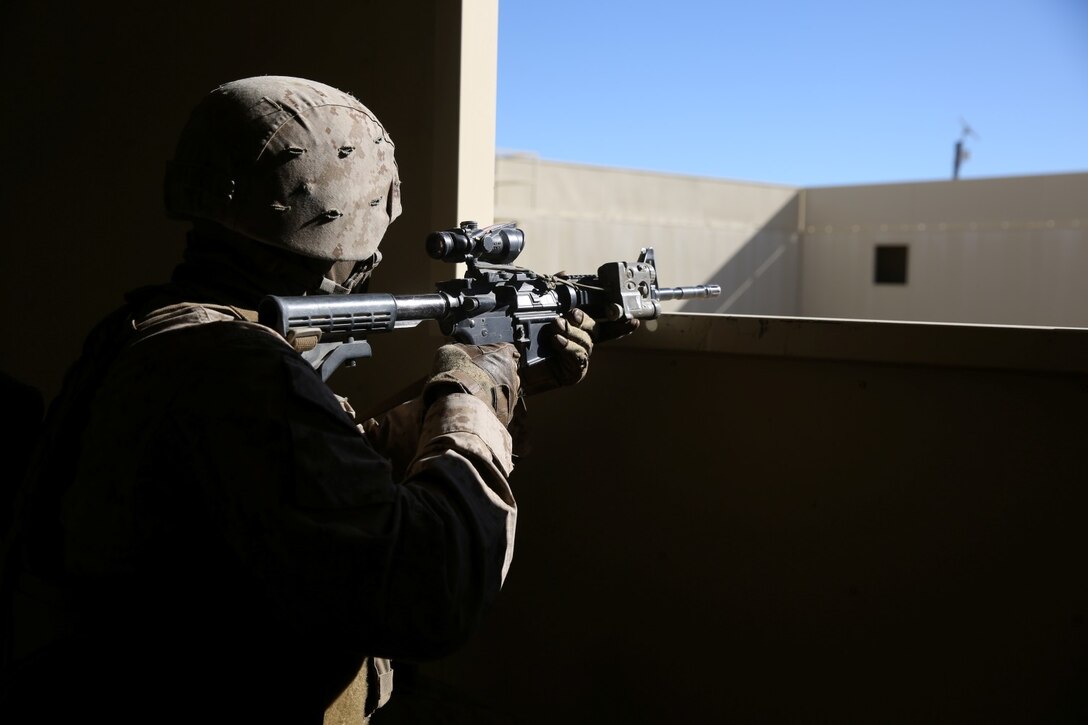 Lance Cpl. Kaleb Walker, rifleman, Bravo Company, 1st Battalion, 7th Marine Regiment, and a native of Long Island, N.Y., provides security during a counterinsurgency exercise on Range 220 at Marine Corps Air Ground Combat Center Twentynine Palms, Calif., Dec. 9, 2013. The $140 million urban warfare training facility consists of more than 1,000 buildings and is divided into four sectors. The buildings replicate what can be found in an urban town to include gas stations, factories, one story complexes, marketplaces and multiple story buildings. The battalion is slated to continue a vigorous training schedule before deploying to Afghanistan this spring.