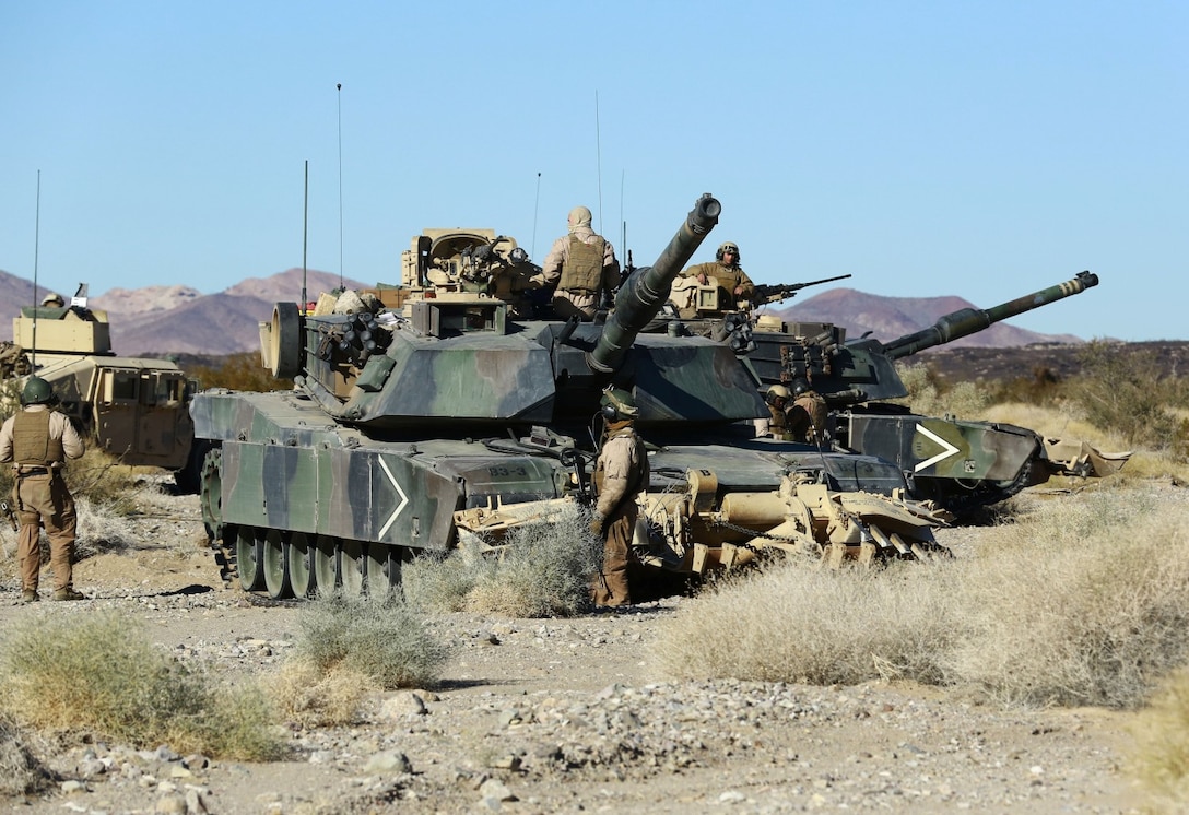 Marines with 1st Tank Battalion perform a final check on their M1A2	 Abrams tank before beginning a mechanized raid in support of Exercise Steel Knight 2014 at Marine Corps Air Ground Combat Center Twentynine Palms, Calif., Dec. 13, 2013. The assault utilized both air and ground elements to eliminate their objective. Steel Knight is an annual exercise that includes elements from the entire I Marine Expeditionary Force (MEF). The exercise focuses on conventional operations and provides realistic training that prepares Marines for overseas operations. (U.S. Marine Corps photo by Cpl. James Gulliver/Released)
