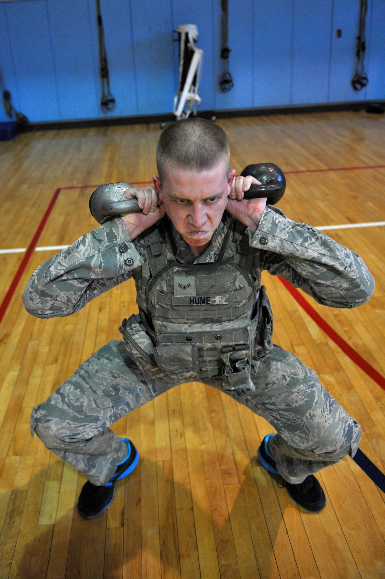 A member of the 51st Security Forces Squadron performs kettle bell squats during a Combat Readiness Course at Osan Air Base, Republic of Korea, Dec. 19, 2013. During the combatives course, participants learned and utilized grappling techniques for use in neutralizing threats from would-be attackers. (U.S. Air Force photo/Staff Sgt. Emerson Nuñez)
