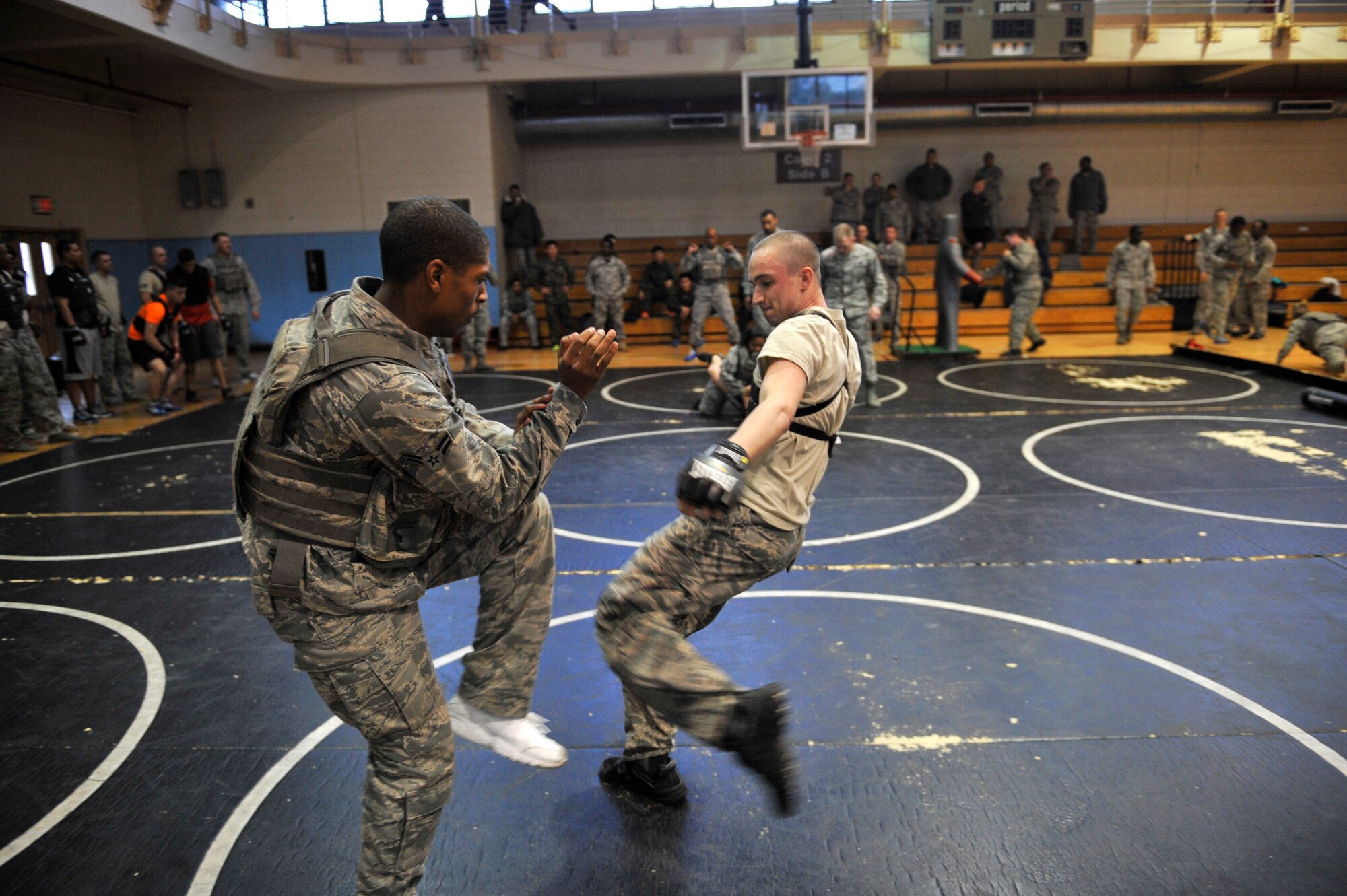 Members of the 51st Security Forces Squadron spar during a Combat Readiness Course at Osan Air Base, Republic of Korea, Dec. 19, 2013. The combatives course allowed defenders to showcase all of the non-lethal tools and techniques in their arsenal. (U.S. Air Force photo/Staff Sgt. Emerson Nuñez)