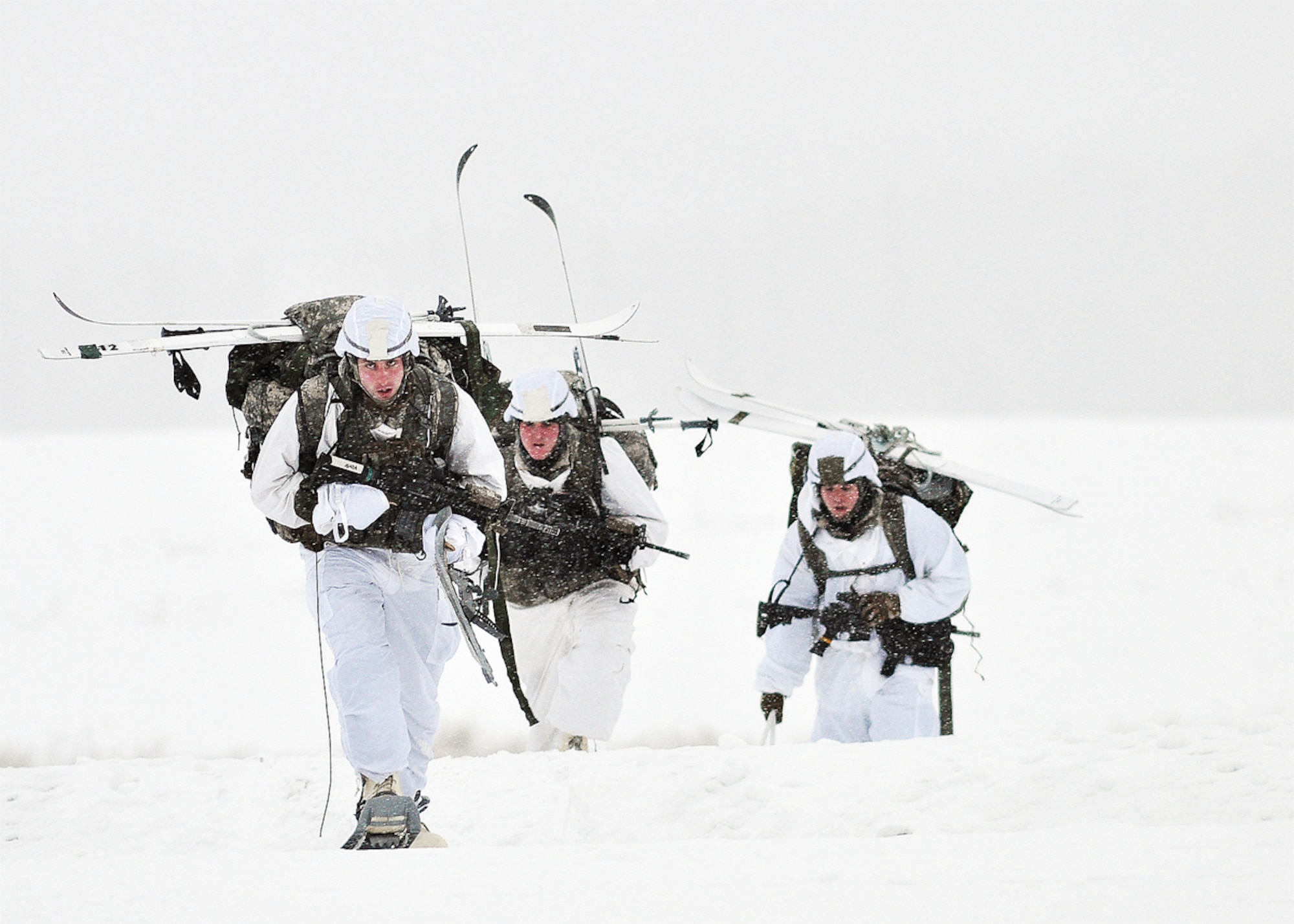 Paratroopers assigned to 1st Squadron (Airborne), 40th Cavalry Regiment, snowshoe off the drop zone. (U.S. Army photo/John Pennell)