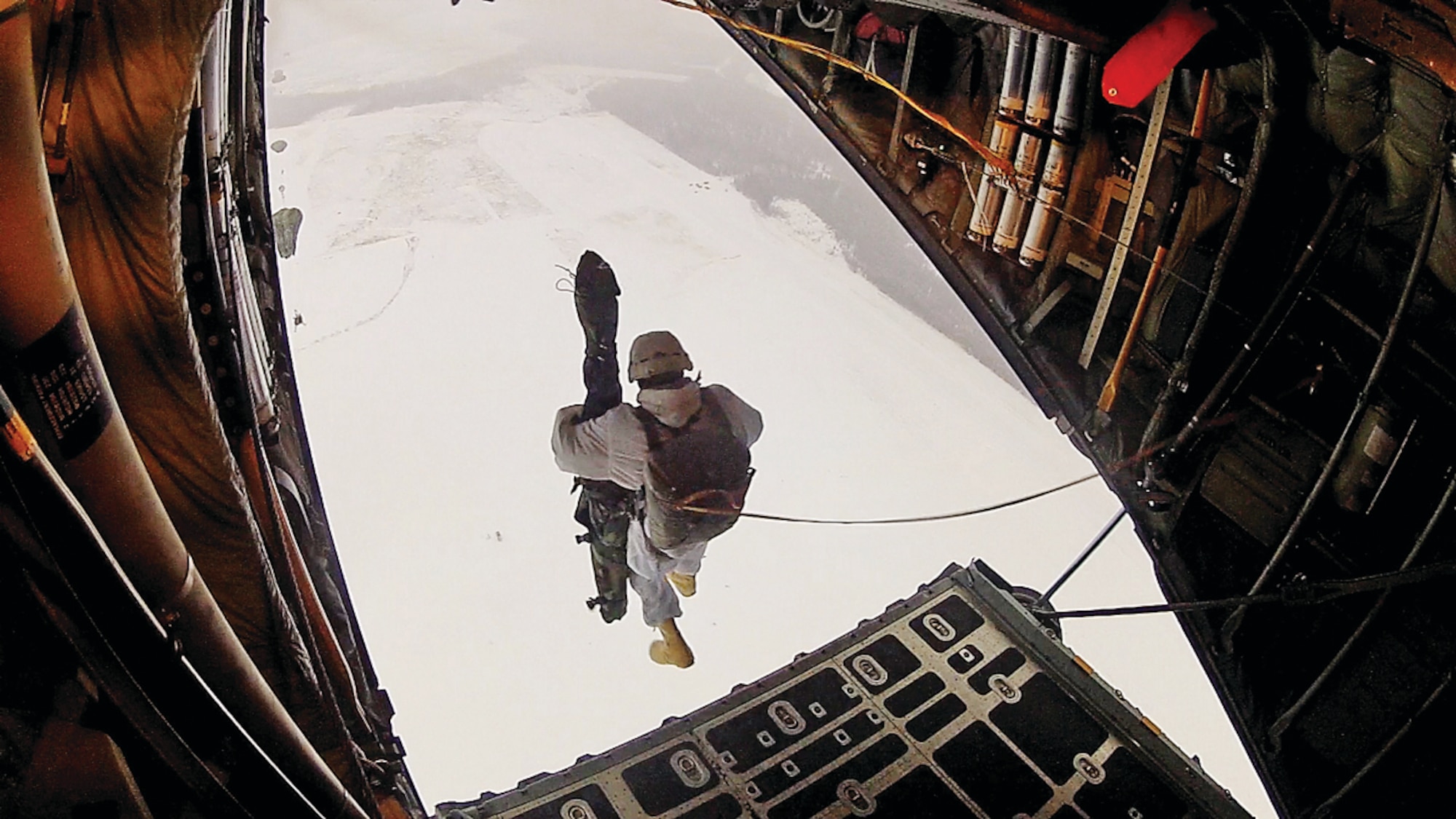 A single video frame shows a 1-40th Cavalry paratrooper jumping out of a C-130 Hercules ramp. (U.S. Air Force image/Senior Airman Sarah Trachte)