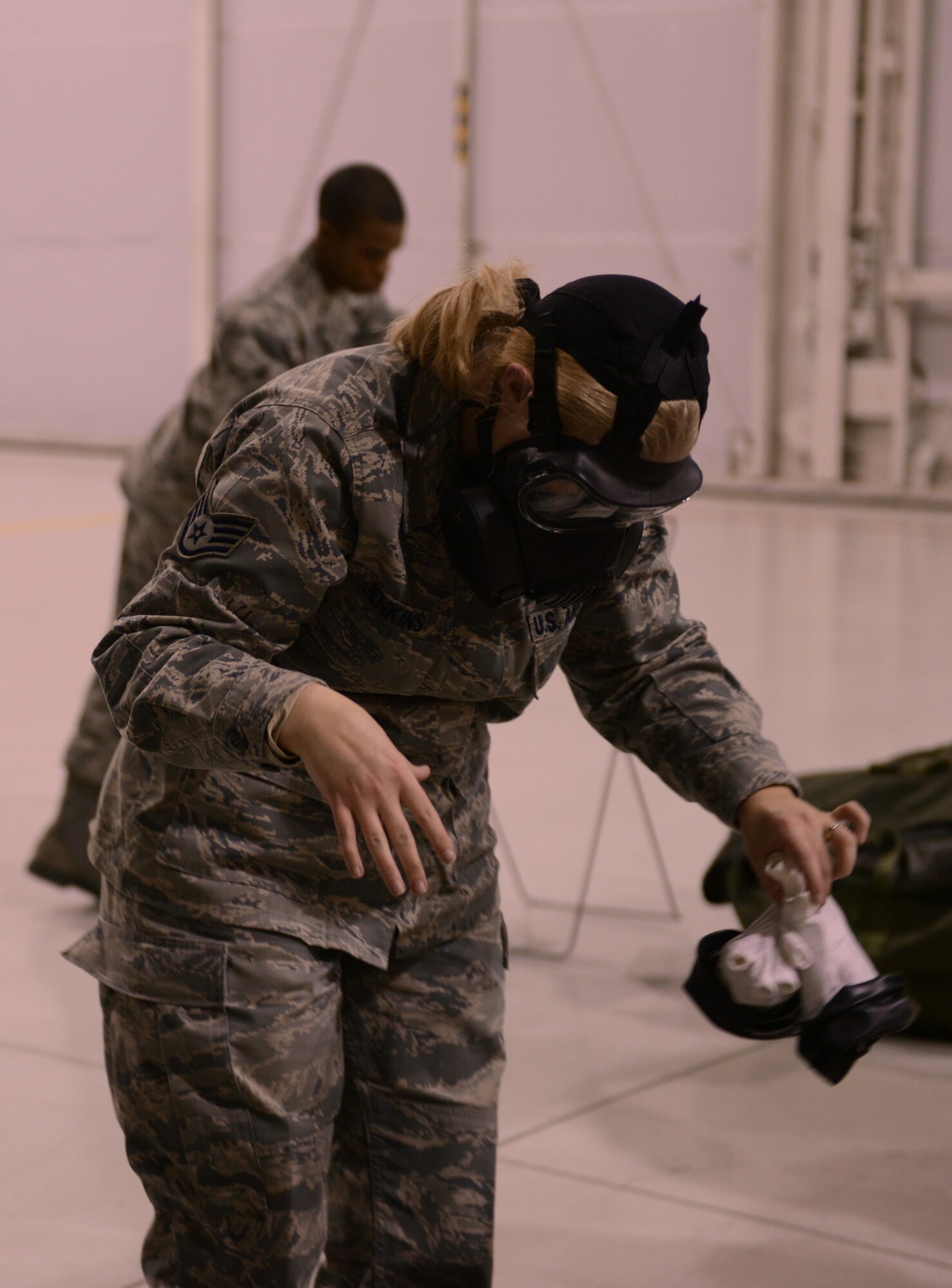 Staff Sgt Anastacia Jenkins, 366th Comptroller Squadron budget analyst, follows decontamination procedures at the contamination control area (CCA) after a simulated chemical attack Dec. 18, 2013, at Mountain Home Air Force Base, Idaho. The CCA was the final event of the operational readiness exercise. (U.S. Air Force photo by Airman 1st Class Malissa Lott/ RELEASED)